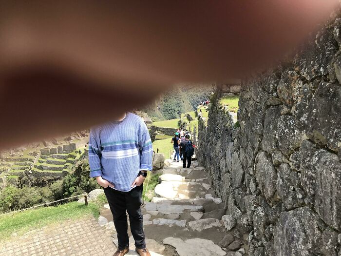 A man poses for a photo at Machu Picchu, but a finger obstructs the lens, a trip that didn't go as planned.