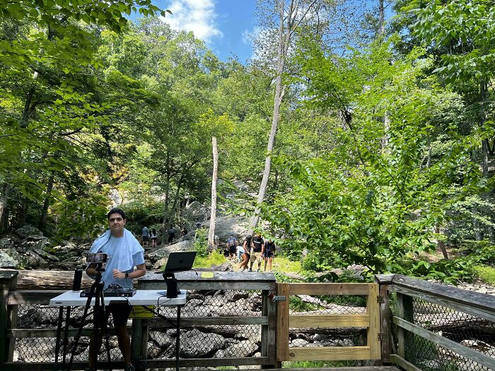 A DJ set up in a natural park, suggesting entitled folks bringing an unexpected party to the outdoors.