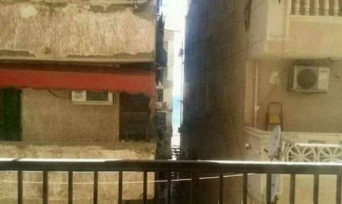 A narrow alleyway between old buildings, showing a trip that didn't go as planned.