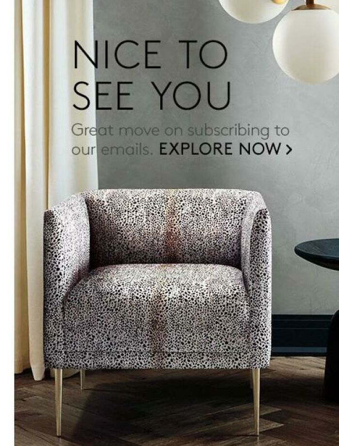 An upholstered armchair with a black and white speckled pattern that appears discolored, illustrating a design fail.