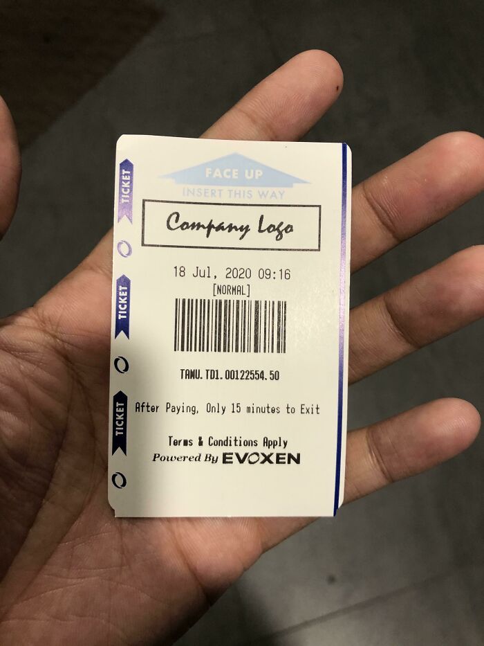 A hand holding a ticket with a QR code and instructions, highlighting an impressive design fail in the ticket layout.