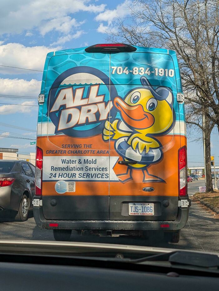 Van with a funny design fail, an advertising duck looking like it is peeing on the side of the vehicle.
