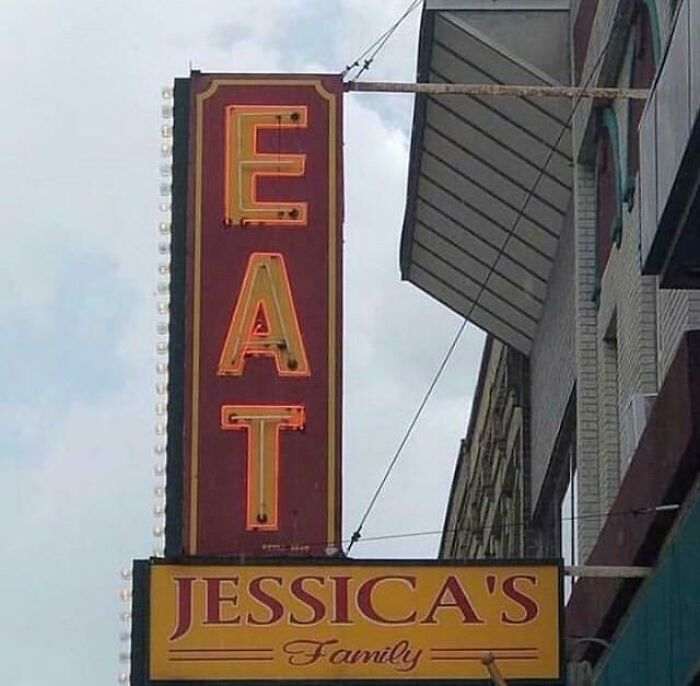 A restaurant sign with the letters EAT stacked vertically, a design fail. Below it, a sign reads Jessica's Family.