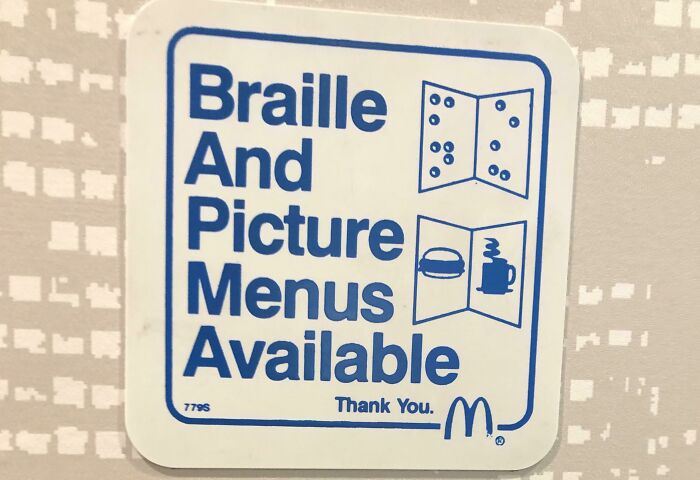 A white sticker with blue text: Braille And Picture Menus Available, featuring a design fail in the acronym BAPMA.