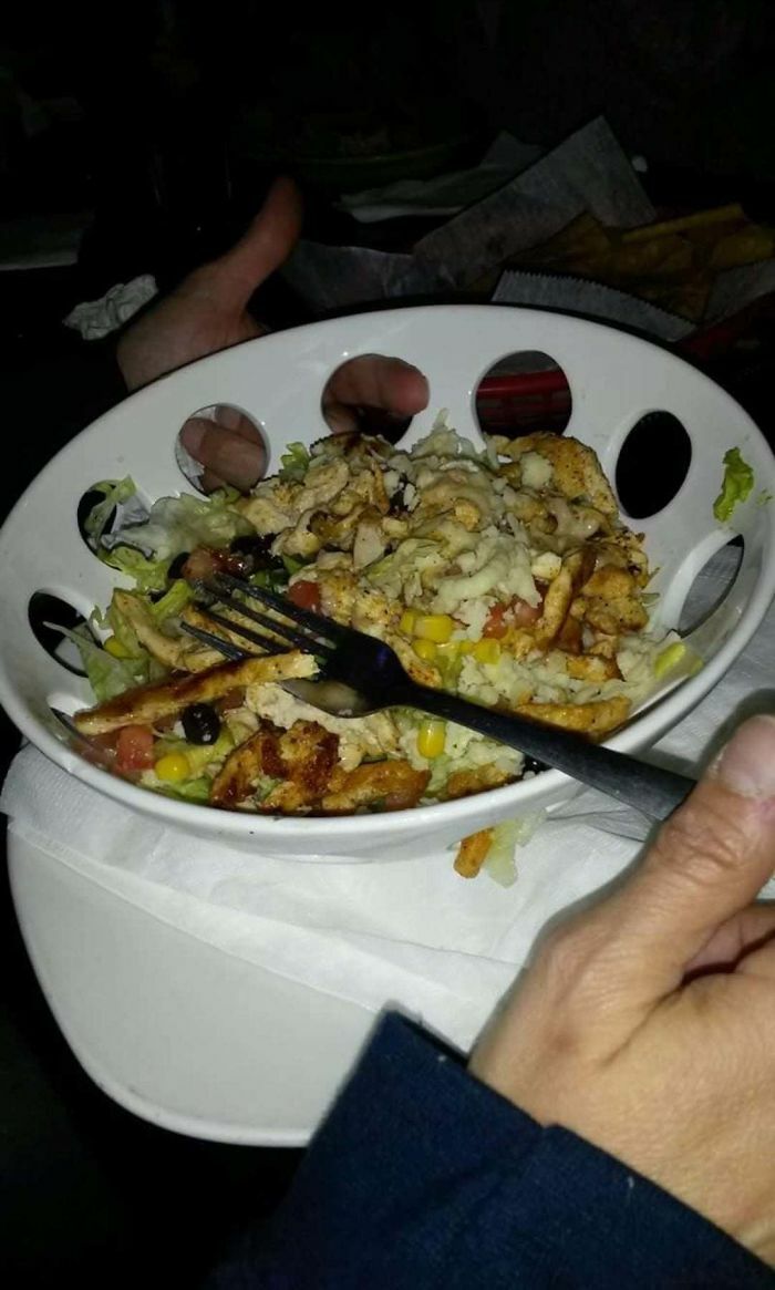 A salad served in a bowl with large, inconvenient holes around the rim, an obvious design fail.