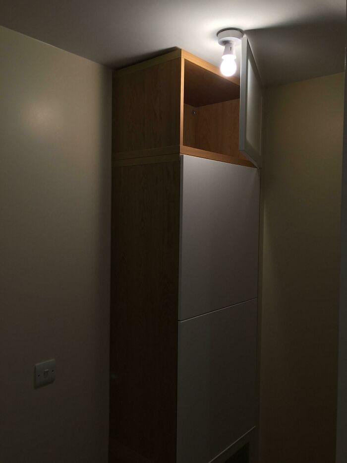 Hilariously bad DIY example: a bare light bulb hanging from the ceiling above a tall cabinet.