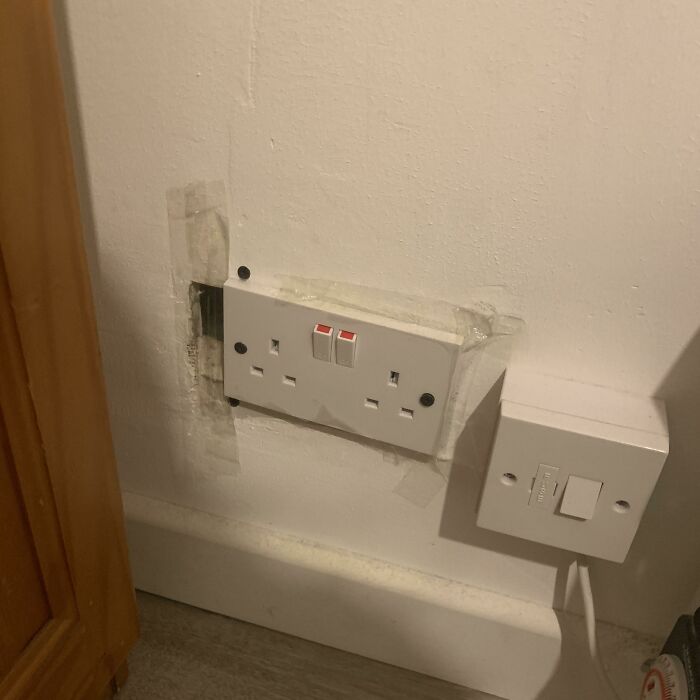 A hilariously bad DIY example: poorly installed electrical sockets on a wall, with visible tape and wires.