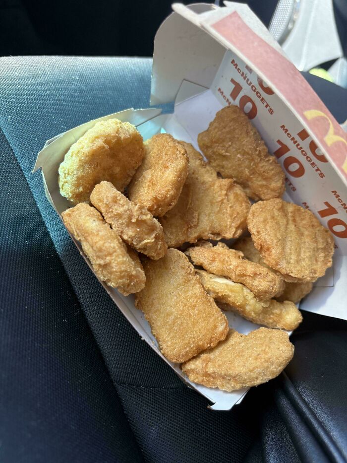 An open box of 10 McDonald's McNuggets, a weird and unexpected amount, making the day more interesting.