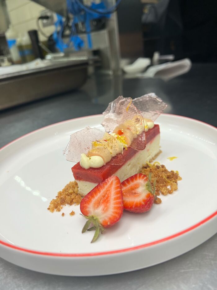 A beautifully plated dessert with strawberries, highlighting an incredible accomplishment.