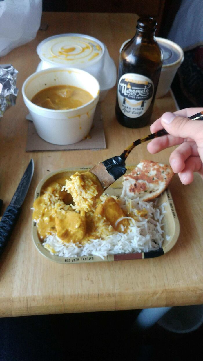 A hilariously bad DIY example of a person eating curry with a makeshift utensil made from a brush, showing a poor attempt to fix it.