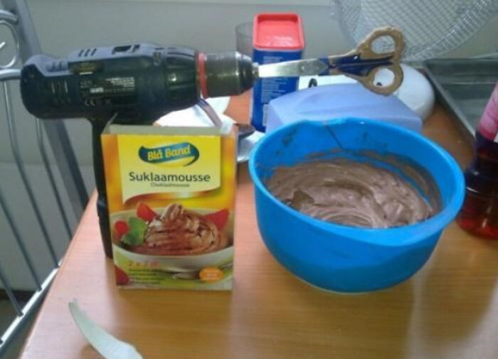 A hilariously bad DIY example of a drill with scissors attached, mixing dessert, demonstrating a poor attempt to fix it.