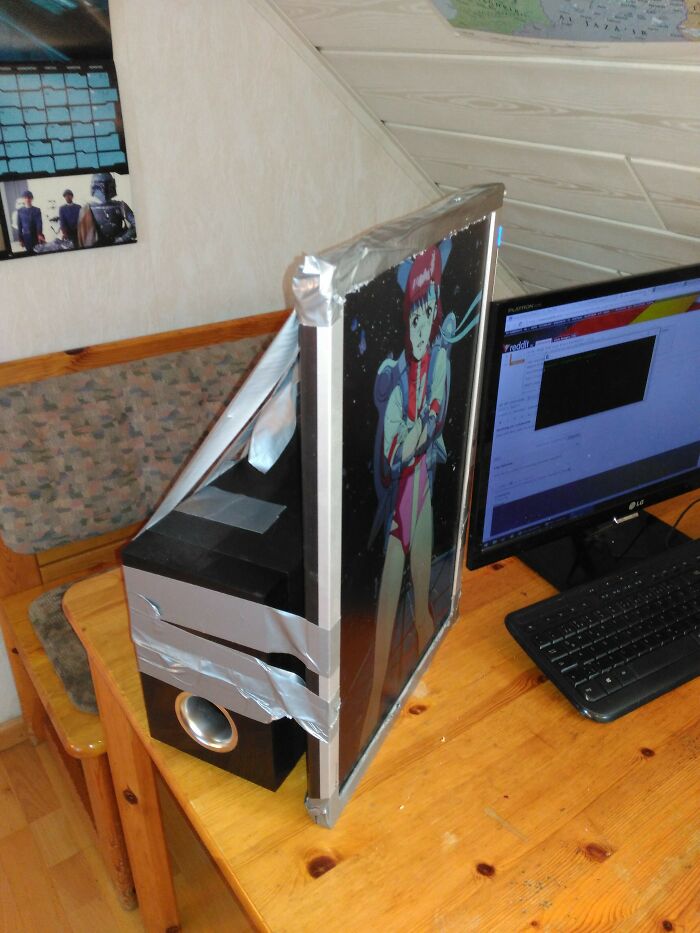 A hilariously bad example of DIY: a computer monitor taped to a speaker with duct tape, showing a DIY fix.