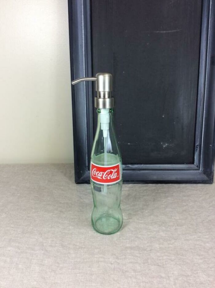 Hilariously bad DIY: A Coca-Cola bottle repurposed as a soap dispenser, sitting on a counter.
