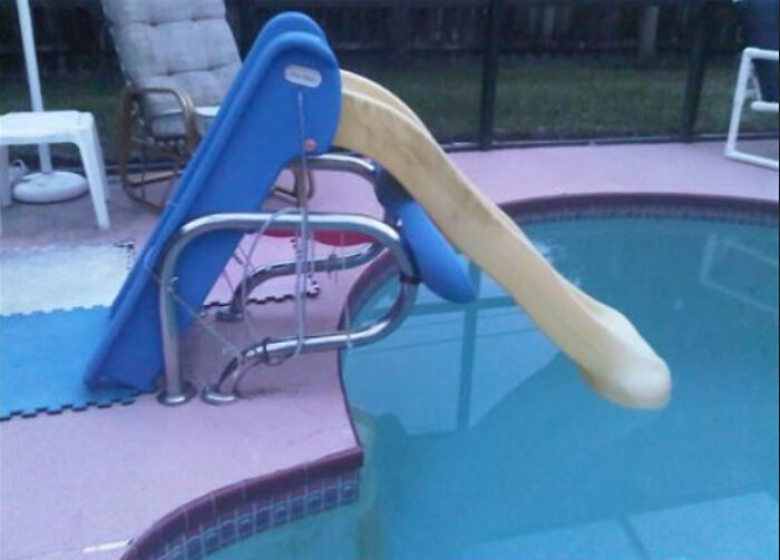 A hilariously bad DIY pool slide that leads into the pool but is too high to be safe.