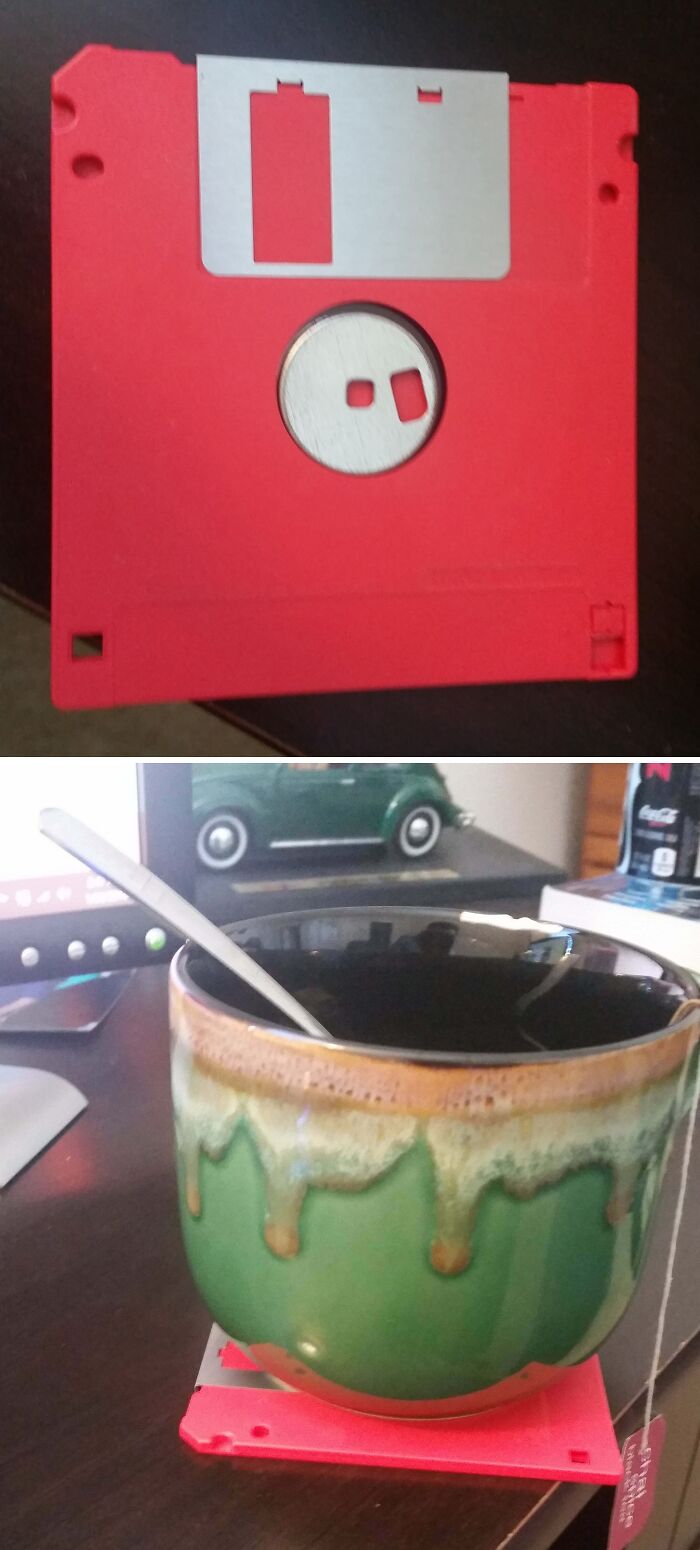 Hilariously bad DIY coaster made from a red floppy disk, under a mug of tea.