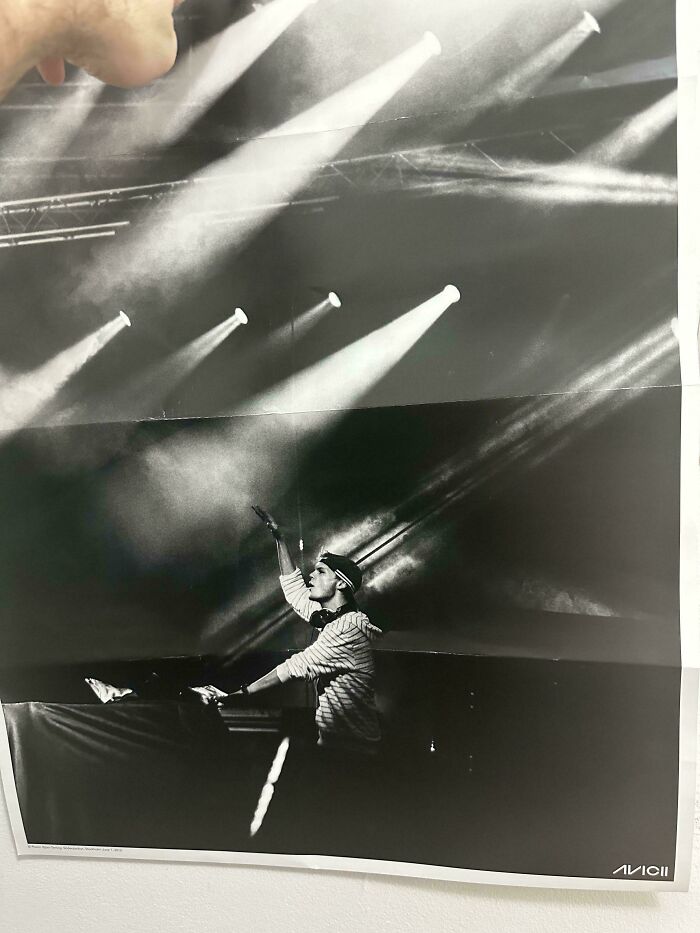 A mildly infuriating obstacle: a black and white concert poster with noticeable creases from being folded.