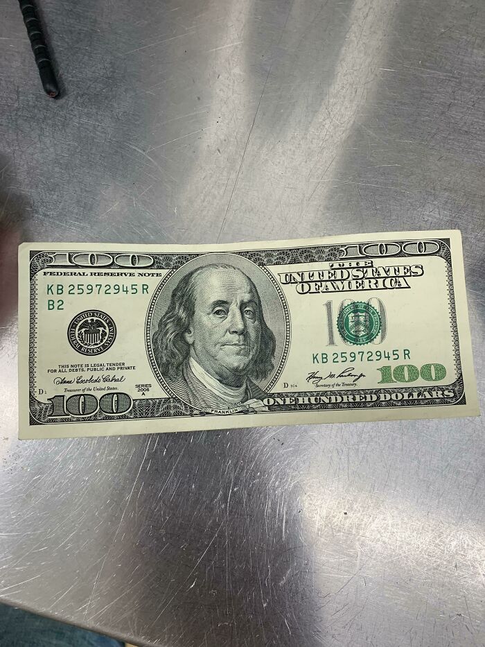 A hundred dollar bill is pictured on a metallic surface, illustrating a mildly infuriating obstacle.