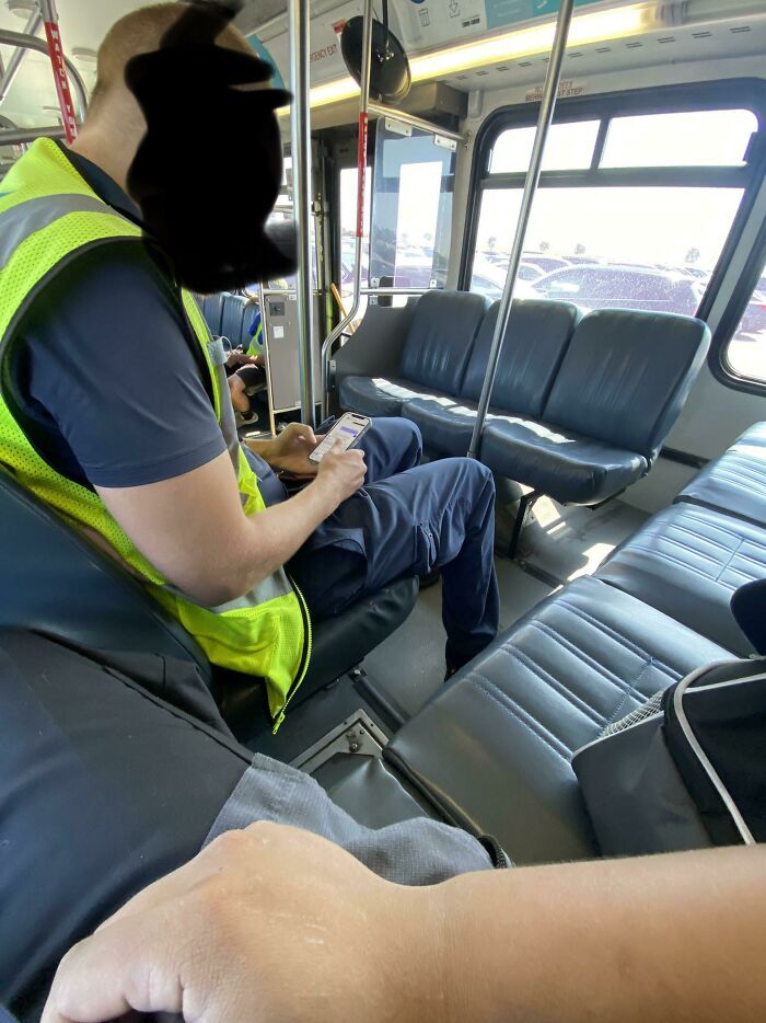 A man on a bus with his feet on the opposite seat, a mildly infuriating obstacle for other passengers.