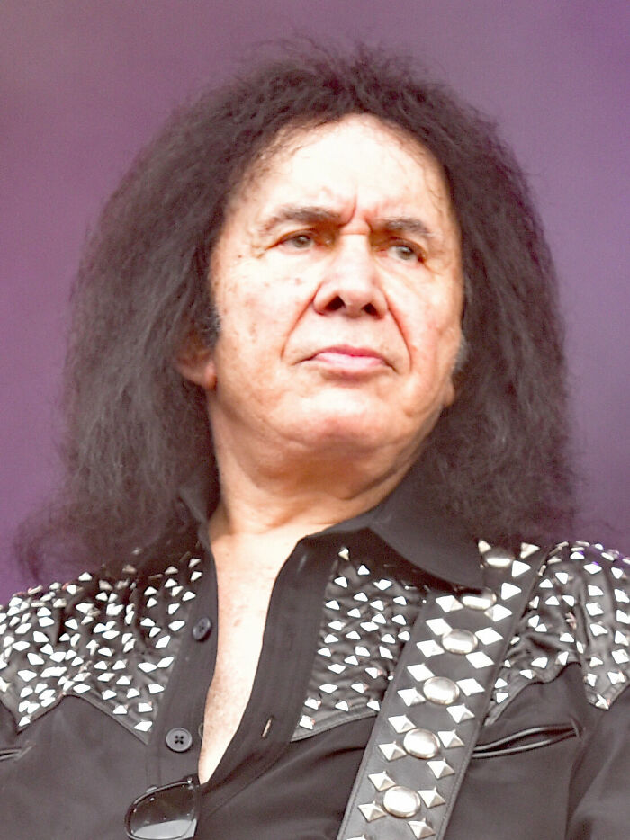 Gene Simmons, rock legend, performs live. This image highlights his iconic career highlights and musical impact.