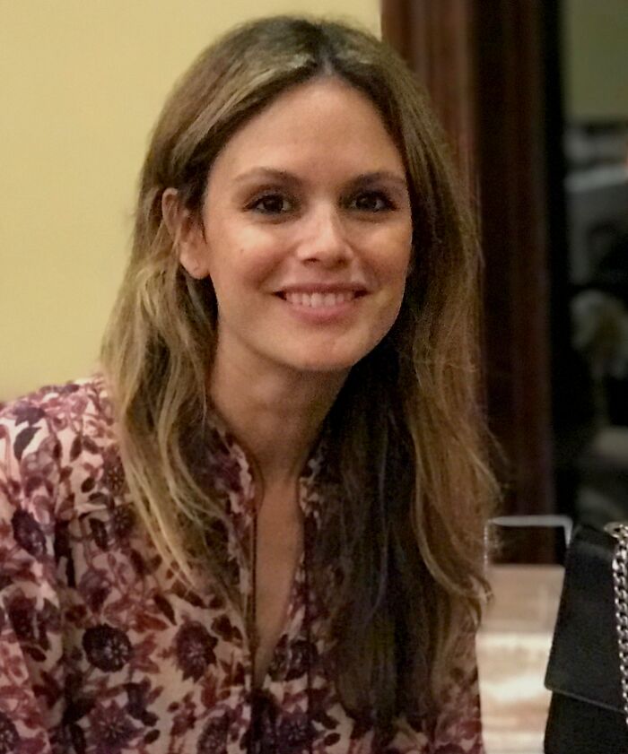 Rachel Bilson, known for her career highlights, smiles while wearing a floral top.
