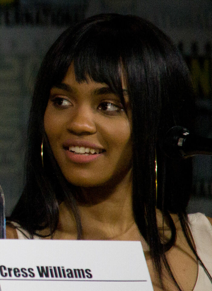 China Anne McClain smiling, wearing hoop earrings, captured during an event highlighting her career.