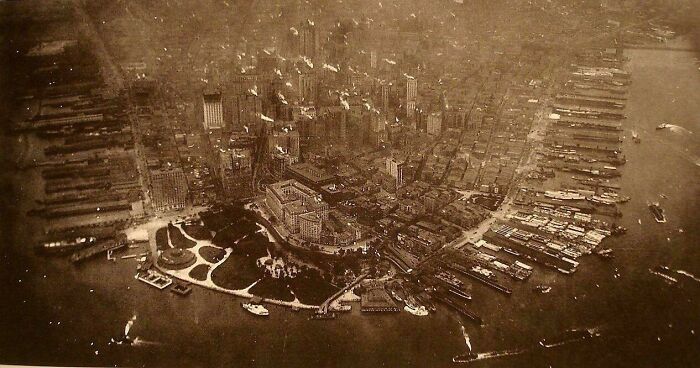 A rare photo from American history captures an aerial view of a densely packed city with a waterfront and many boats.