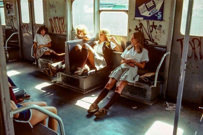 Rare American History photo: Four young women in uniform sit in a graffiti-covered subway car.