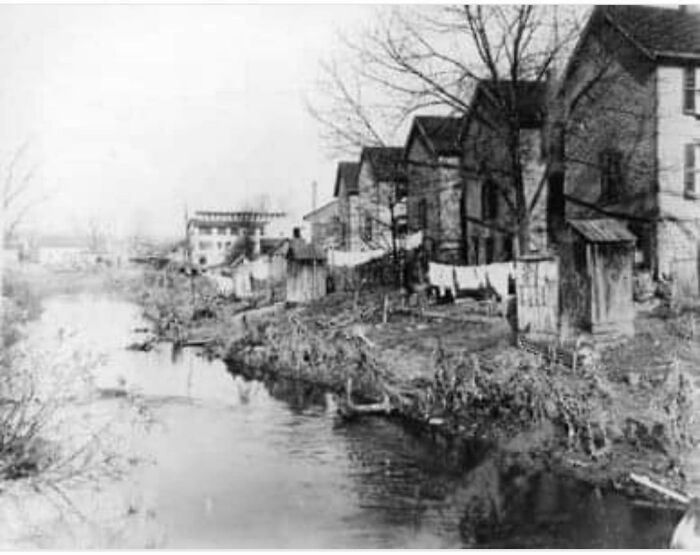 Rare photo of a fascinating American historical residential area along a narrow river.