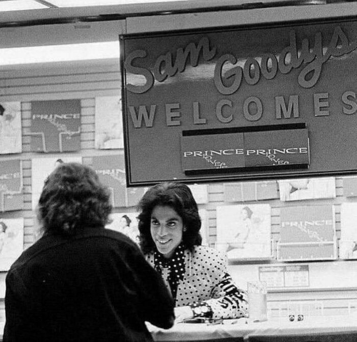 Prince interacting with fans at a Sam Goody record store, a fascinating photo from American history.
