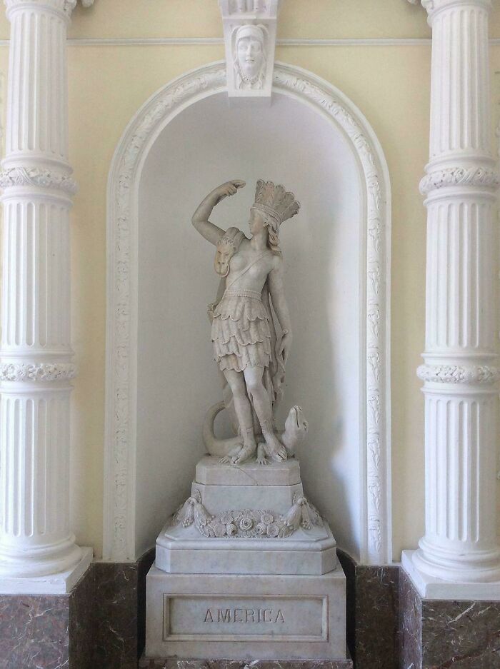 A fascinating photo from American history showing the America statue, a classic marble sculpture in a bright alcove.