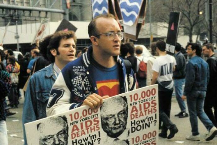 A man holds a protest sign at an American history event, highlighting rare photos from American history.