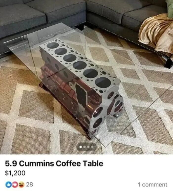 A coffee table made from a 5.9 Cummins engine block with a glass top, a quirky online marketplace screenshot.