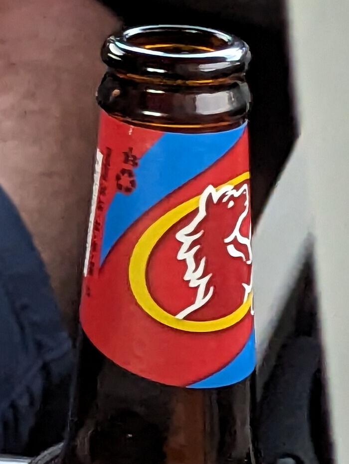 A close-up of a beer bottle with a red and blue label featuring a white horse design, a thing people lost hope to find.