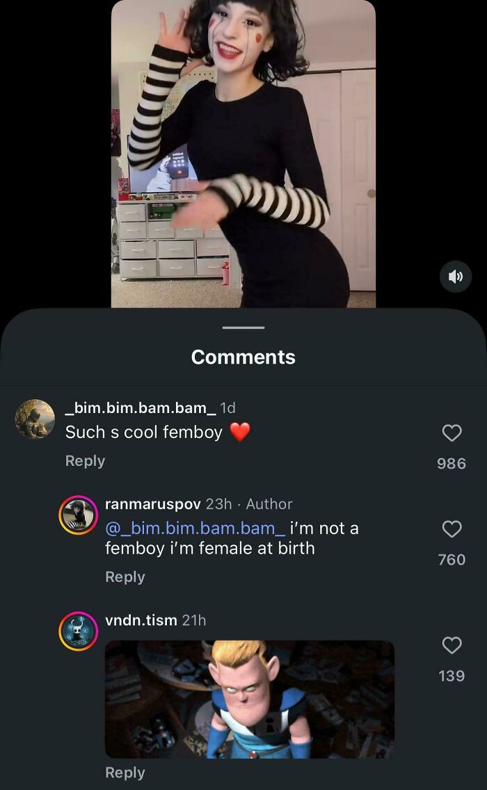 A blursed video of a person in a striped top and black dress with comments below, one misgendering them.