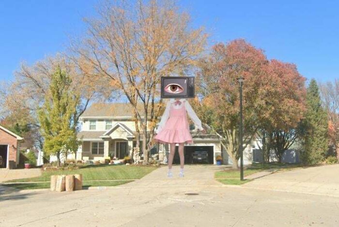 A surreal image on Google Maps street view of a figure in a pink dress with a TV for a head, an odd find.