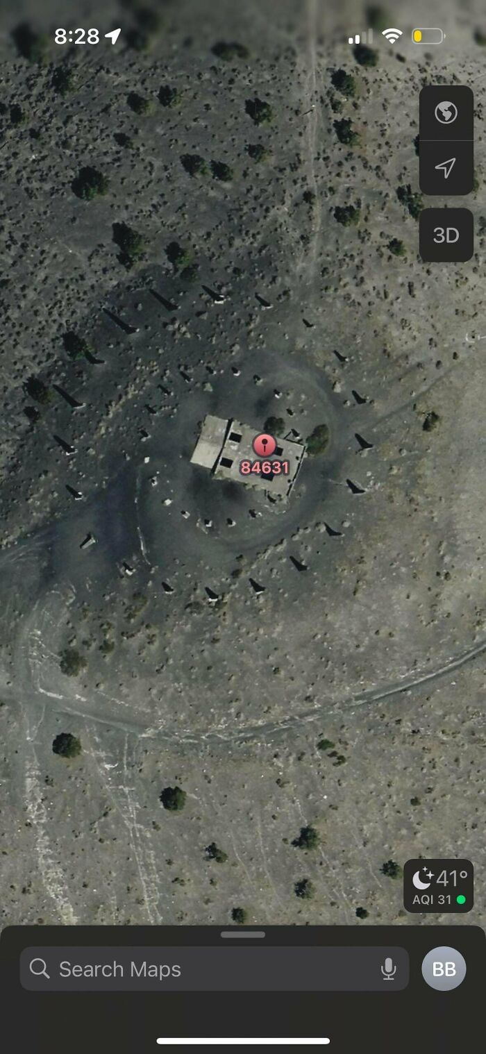 Odd things found on Google Maps: an aerial view of a building in a desolate area with a red pin showing a location.