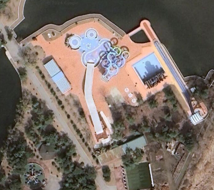 Odd things found on Google Maps: an aerial view of a water park with various slides and pools next to a body of water.