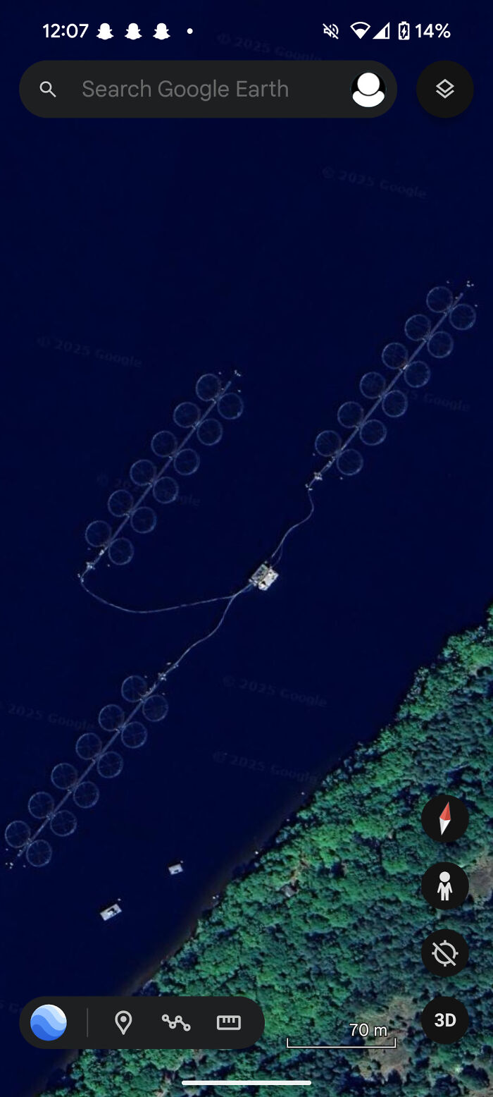 A Google Earth view shows a fish farm with circular pens in a lake, an odd thing found by people.