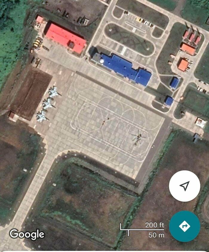 Odd things found on Google Maps: an aerial view of an airfield with jets and a helicopter.