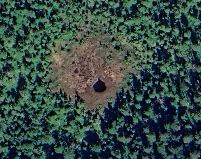 People found odd things on Google Maps, displaying a strange, circular clearing with a dark hole in a forest.