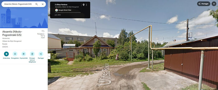 Odd things on Google Maps: A street view of a rural road with a puddle, showcasing unexpected street scenery.