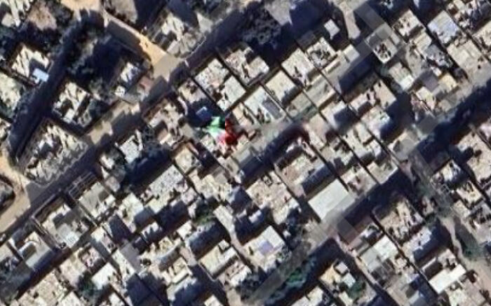 Overhead view of a densely packed urban area with a colorful, possibly distorted, object found on Google Maps.