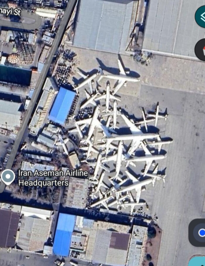 An aerial Google Maps view of Iran Aseman Airline Headquarters, with many planes seemingly piled up, an odd sight.