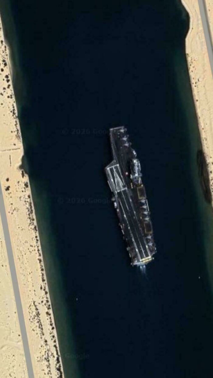 An aerial view of a large ship in a canal, an odd thing people found on Google Maps.