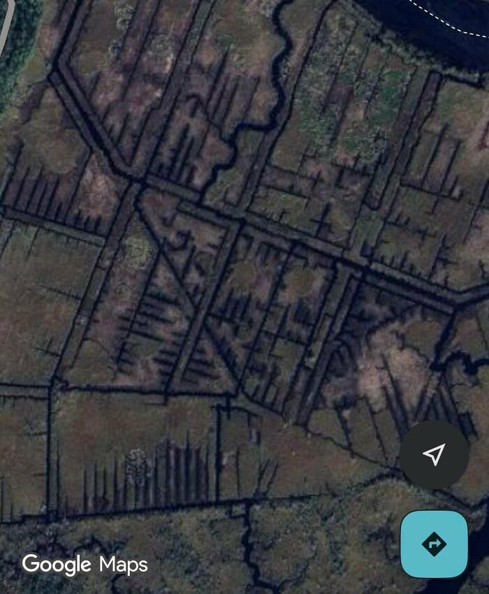 Odd things on Google Maps: an aerial view of geometrically patterned canals or trenches in a marshy landscape.