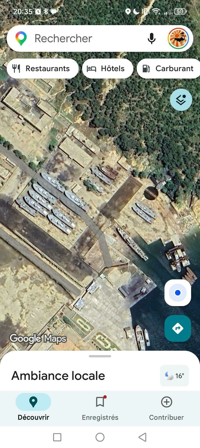 An aerial view of a port on Google Maps with numerous ships docked, showcasing odd things found on Google Maps.