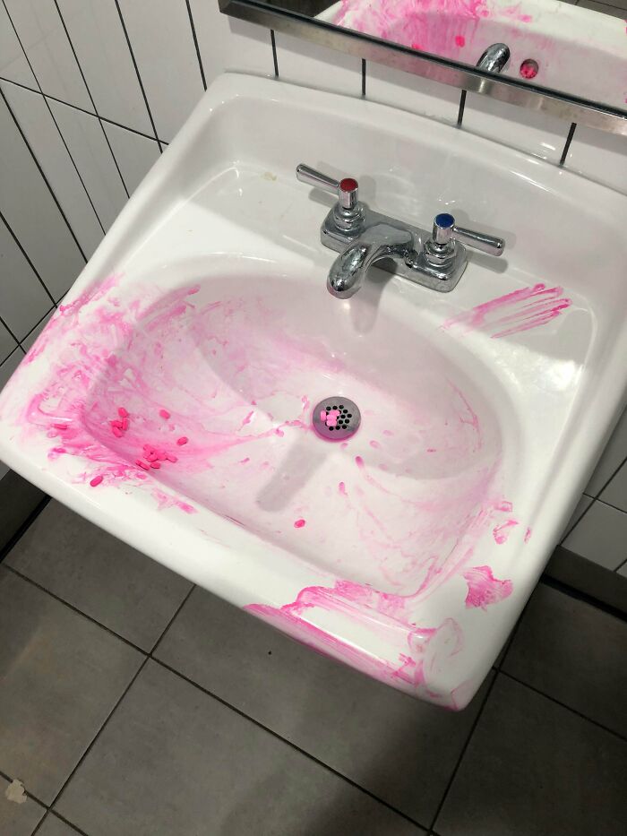 A bathroom sink messy with pink splatters, showing little hope for humanity.