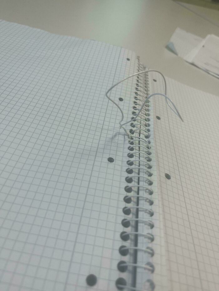 A wire from a spiral notebook is broken, suggesting little hope for humanity in careful handling of everyday items.