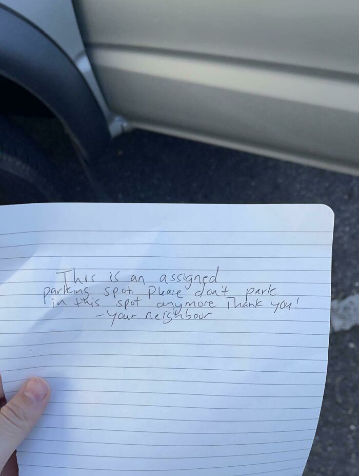 A handwritten note about an assigned parking spot, reflecting little hope for humanity.