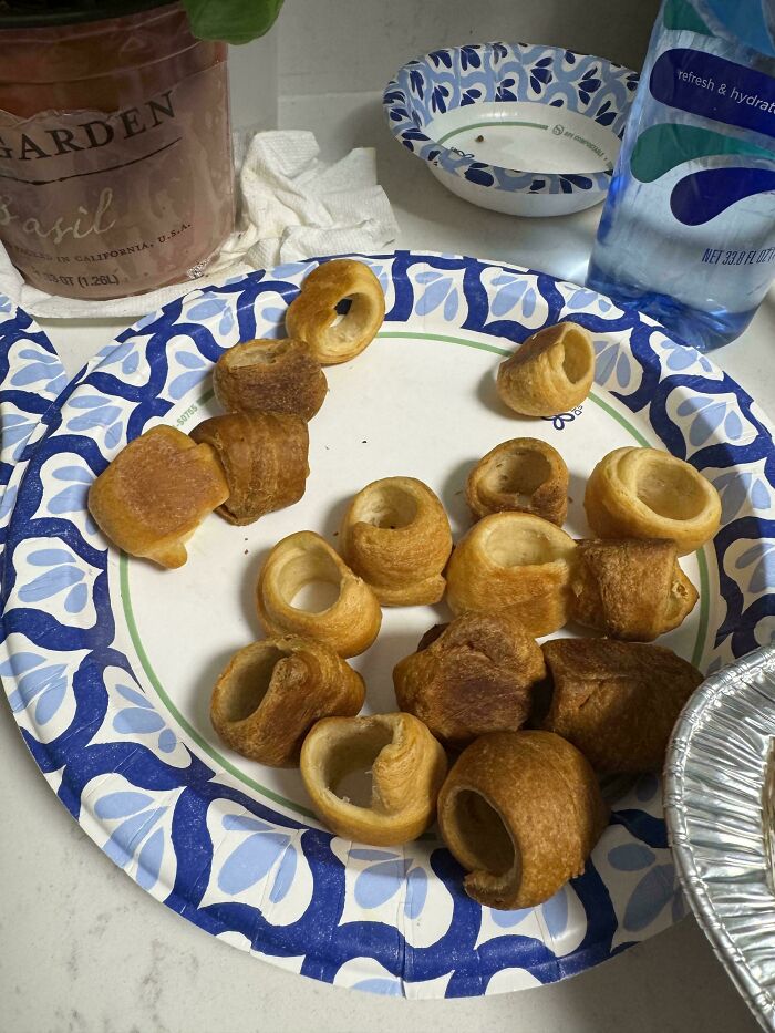 A plate of crescent rolls with their middles removed, depicting little hope for humanity.